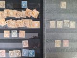 a lot of stamps on display in a glass case
