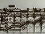 a black and white photo of a large structure with stairs