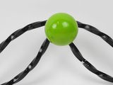 a close up of a tennis racquet with a green ball on it