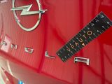 a close up of a sticker on a car ' s emblem