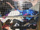 a cart full of clothes that is sitting on the floor