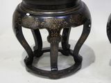 pair of black and gold asian stools on stand with white background