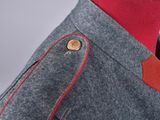 the back of a man ' s jacket with a red shirt underneath it