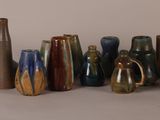 many different types of vases sitting on a table
