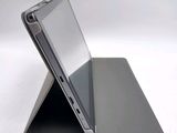 a close up of a laptop on a stand on a white surface