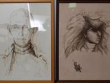 two framed drawings of a man and a woman on a wall
