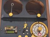 a wooden box with a clock and other items inside of it