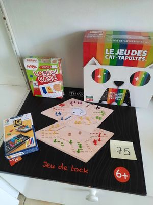 a table with a board game and a box of cards on it