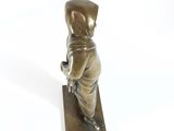 bronze figurine of a boy with a book in his hands