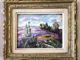 une peinture à l'huile représentant un paysage, dans un cadre doré, accrochée au mur