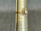 a gold ring sitting on top of a silver cone