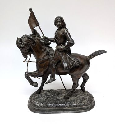 statue of a man on a horse with a flag on its back