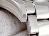 a close up of a watch on a white cloth
