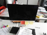 a computer monitor sitting on top of a desk next to a keyboard and mouse