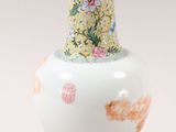 a white vase with a floral design on it