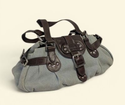 a gray purse with brown straps on a white background