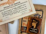 several old french books are sitting on a white surface