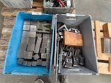 une caisse remplie d'objets métalliques posée sur une palette