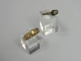 two rings that are sitting on top of a clear box
