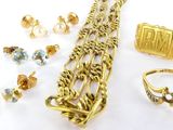 a lot of gold jewelry on a white surface