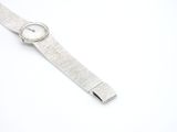 an image of a close up of a wrist watch on a white surface