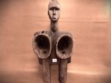 a sculpture of a man with two horns on a wall