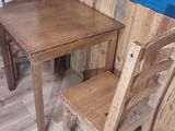 a small table and two chairs in the corner of the room