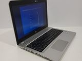 the laptop is open on a white surface with a blue screen