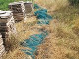 a pile of wood sitting in the middle of a field