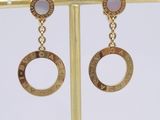 a pair of gold toned earrings with the words ' love ' written on them