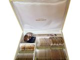 a box with silverware in it on a white surface