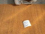a roll of carpet on the floor next to a roll of carpet
