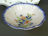 a bowl with a flower design on it and a plate with a flower design on it