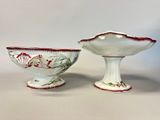 pair of white and red porcelain bowls with floral designs on them