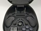 a black case with ear buds in it on a white surface