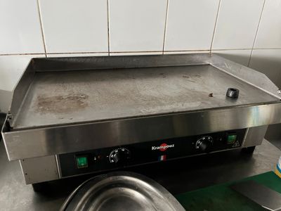 a metal pan sitting on top of a stove in a kitchen