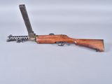 an old rifle with a gun on a white surface