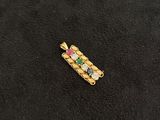 a close up of a piece of jewelry on a black surface
