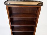 an antique wooden bookcase with a tray on top of it