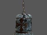a glass bell hanging from a chain on a gray background