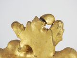 a gold figurine that is sitting on a table