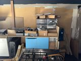 a kitchen with a stove top and a lot of boxes on the counter