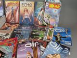 a lot of comic books on a table with a laptop on it
