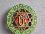 a close up of a metal pin with a star of david on it