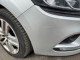 a close up of a car ' s headlight and the front end of the car