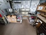 a kitchen with a sink, stove, and other items in it