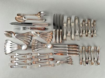 a lot of silverware on a table with spoons and knives