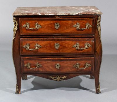 a small chest of drawers with marble top