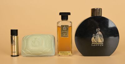 an image of a bottle of perfume next to a soap and a soap bar