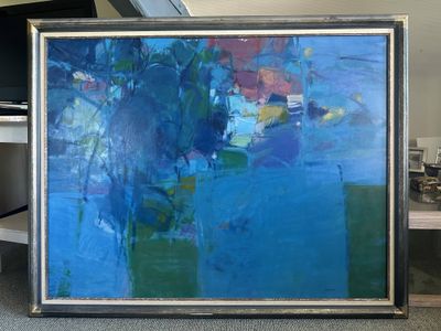 a painting that is sitting on the floor in front of a tv